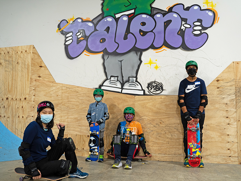 Four Chill youth with skateboards at the Talent Skate park.