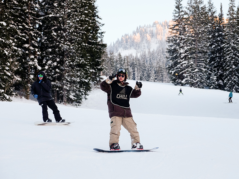 Chill youth snowboarding on the mountain.