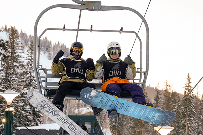 Two Chill youth riding on the chairlift.