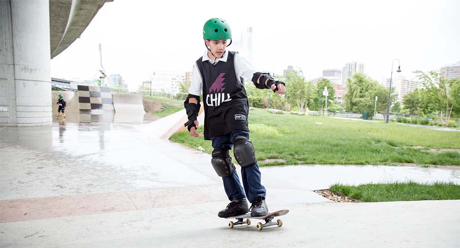 Chill youth skateboarding with the city in the background