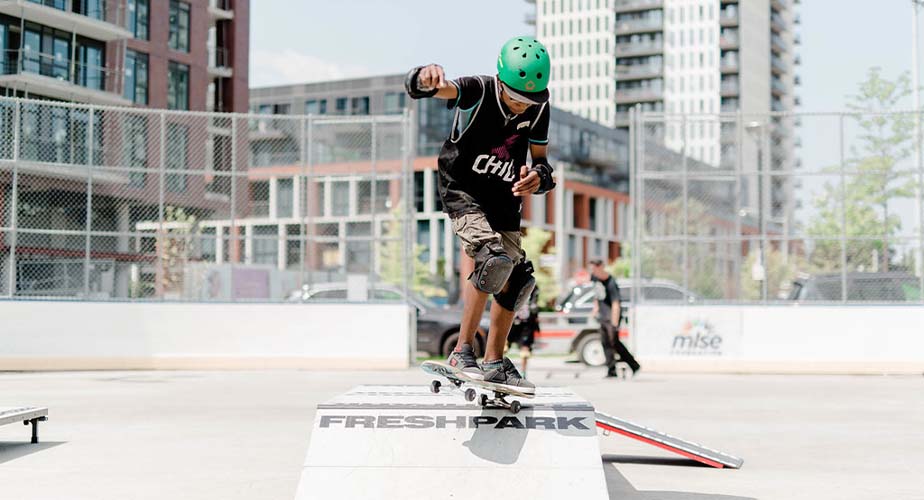 Chil youth is dropping in off a ramp in the summer