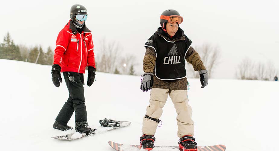 Chill youth learning to stop and an instructor is following him