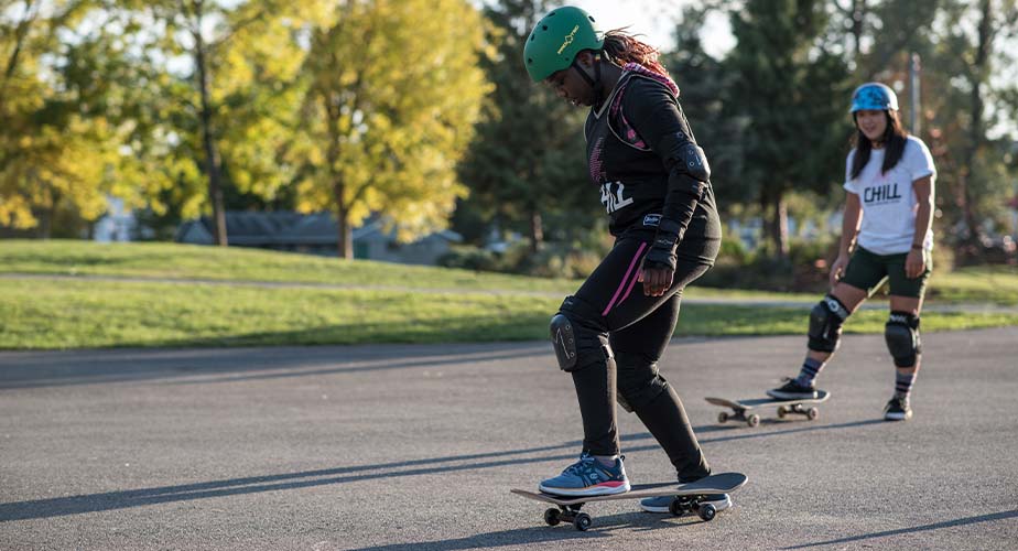 Chill youth mid-push on a skateboarding