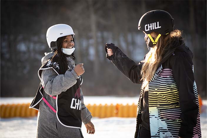 Chill coordinator fist bumping a chill youth