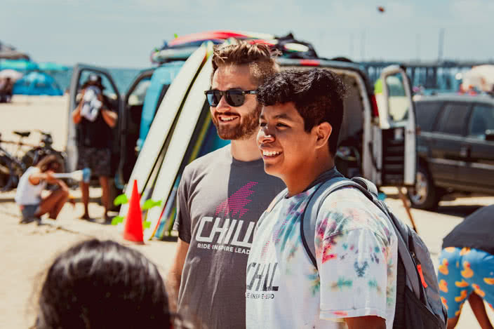 Alex Wiktor, Chill Instructor, Standing with Surf Participant on Beach