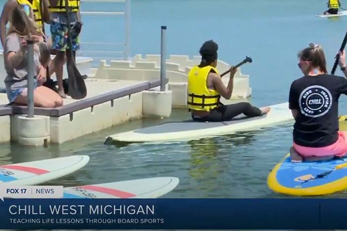 A screenshot of youth paddleboarding from the news coverage.