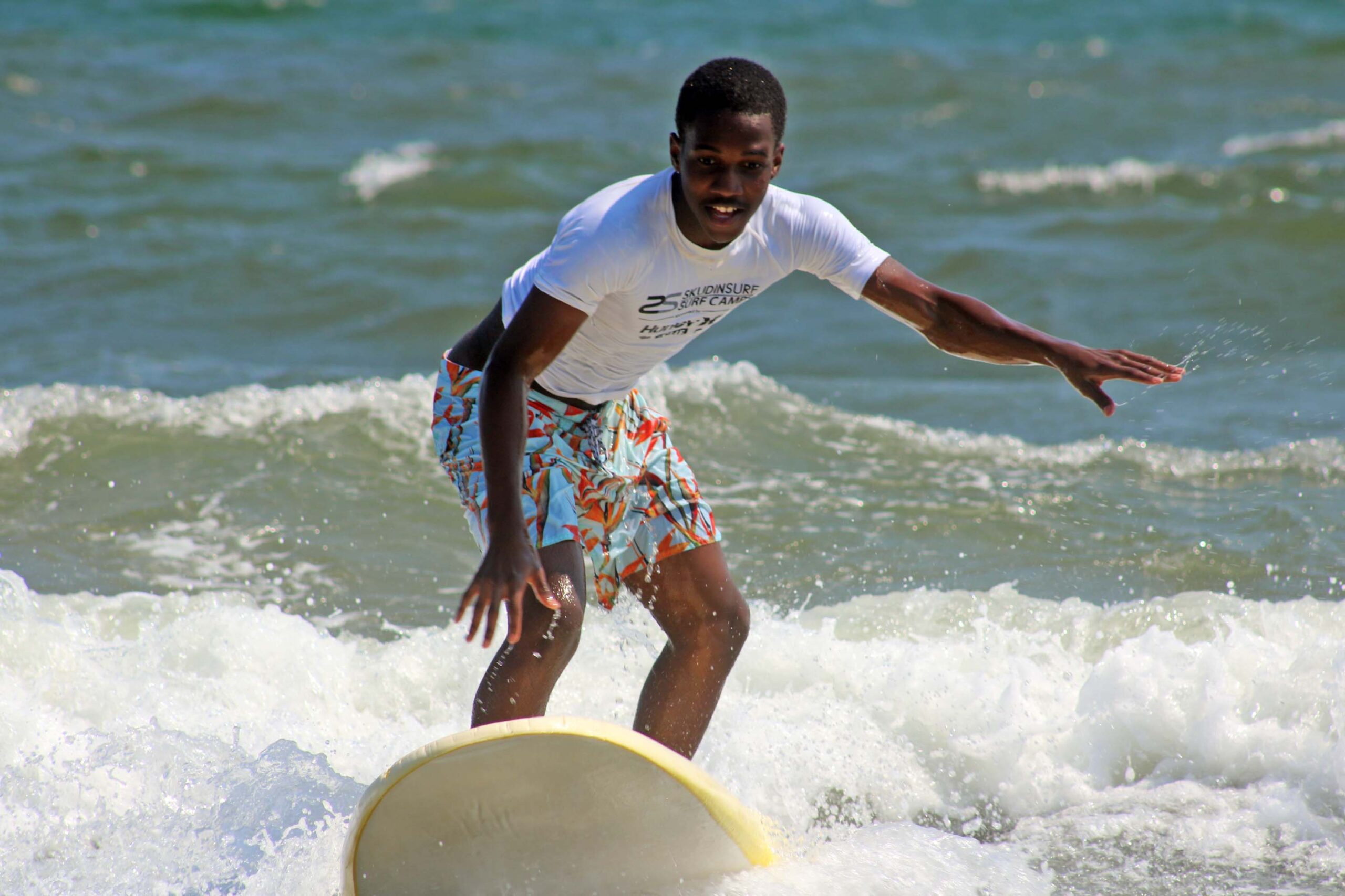 A Chill youth riding a wave.