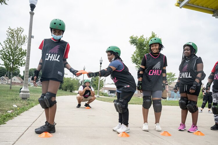 Youth lined up to skate with a Chill instructor in the background.