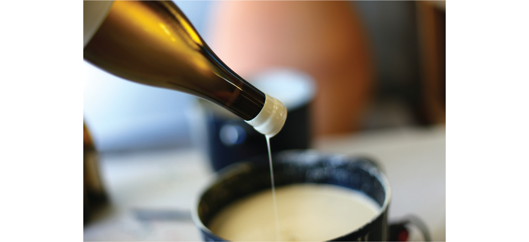 An Arnot-Roberts bottle being dipped in wax.