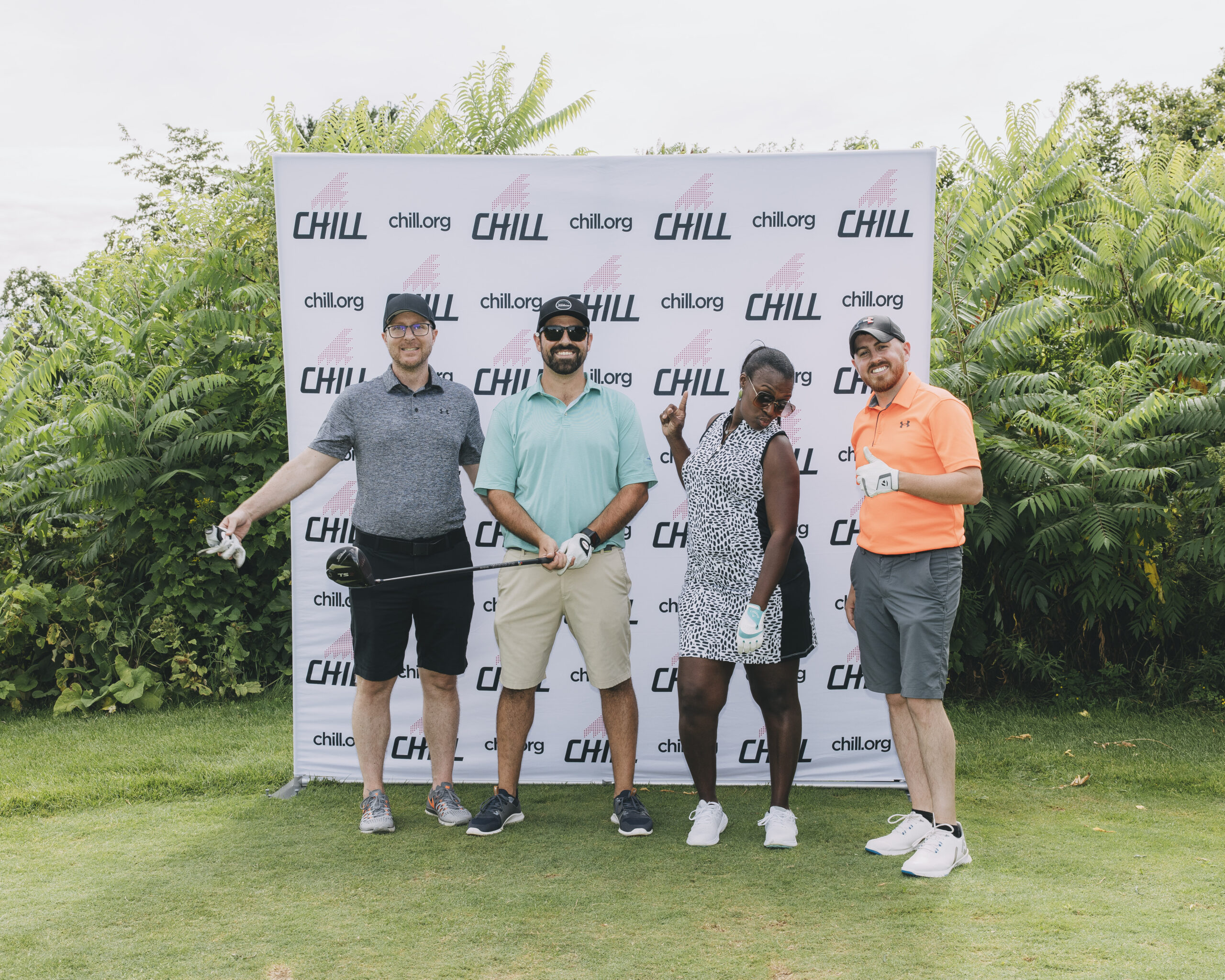 A group of people posing at a Chill golf tournament.